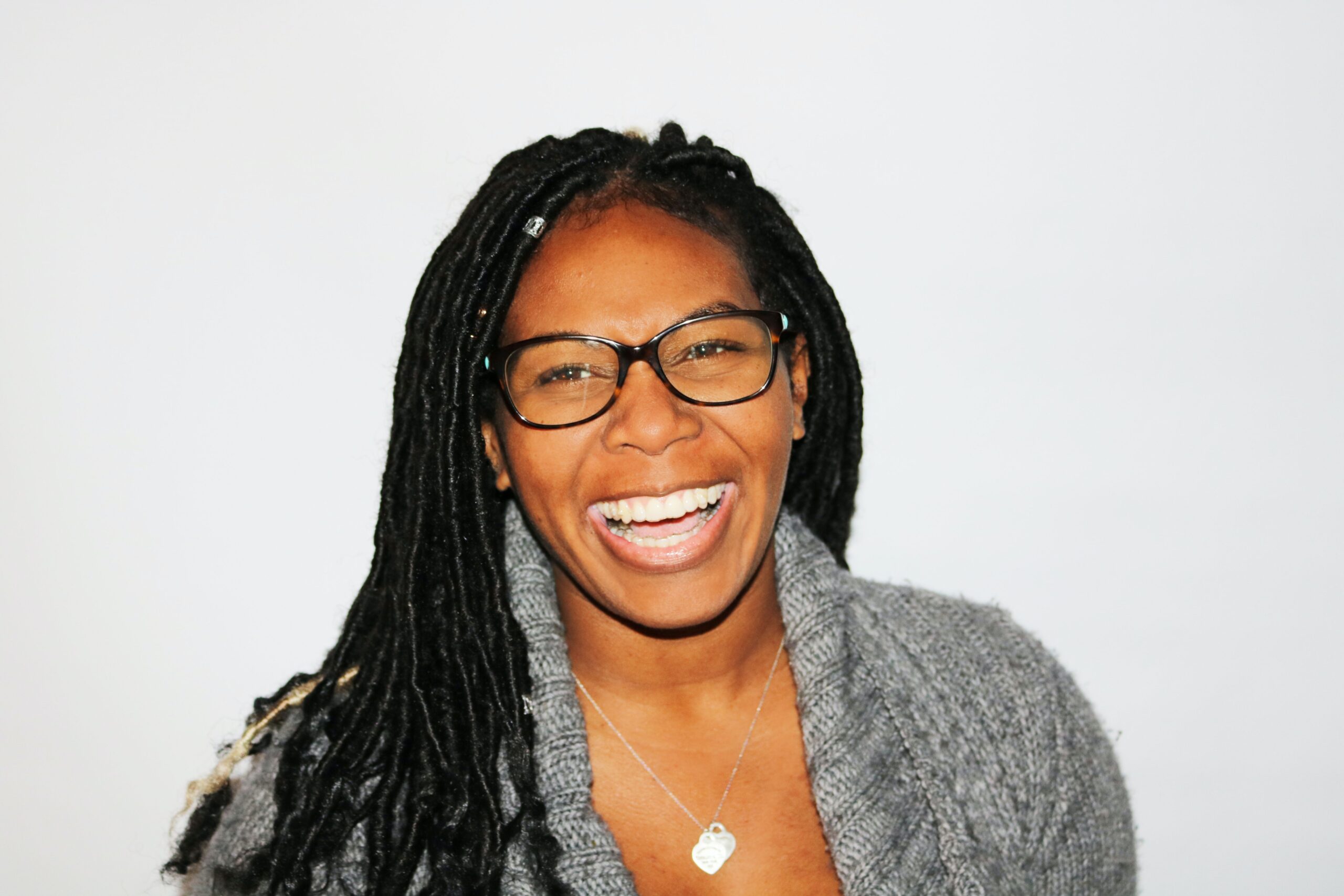 Black Lady Wearing Glasses And Smiling