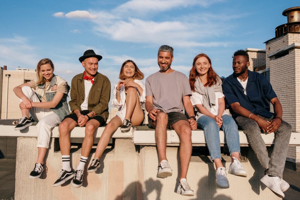 Group Of Friends Sat On Wall looking happy
to live life to the fullest