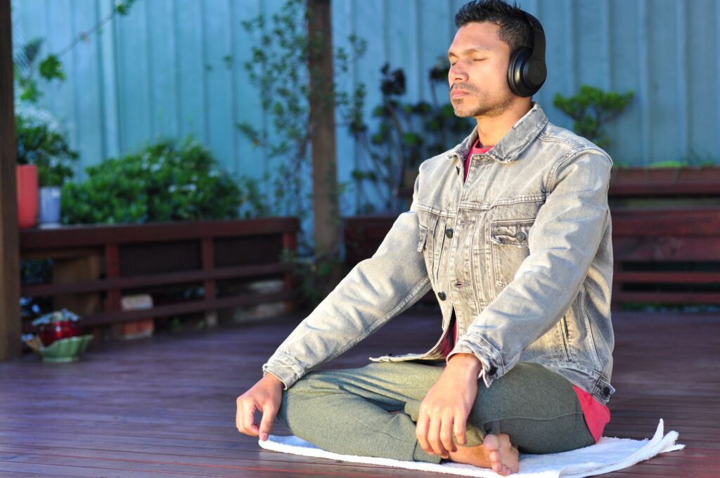 a man practising meditation to music