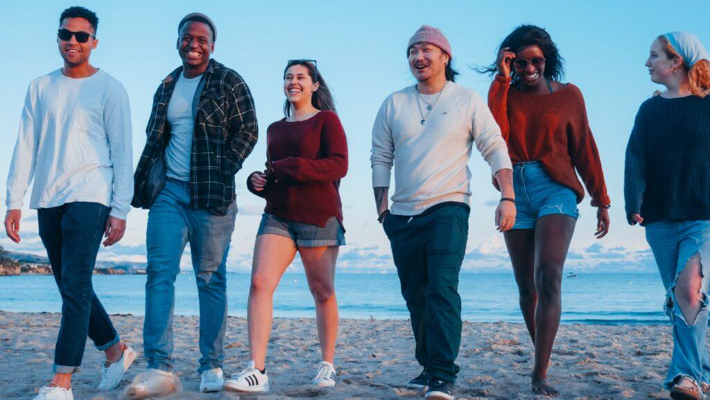 Group Of Friends On Beach Looking Happy