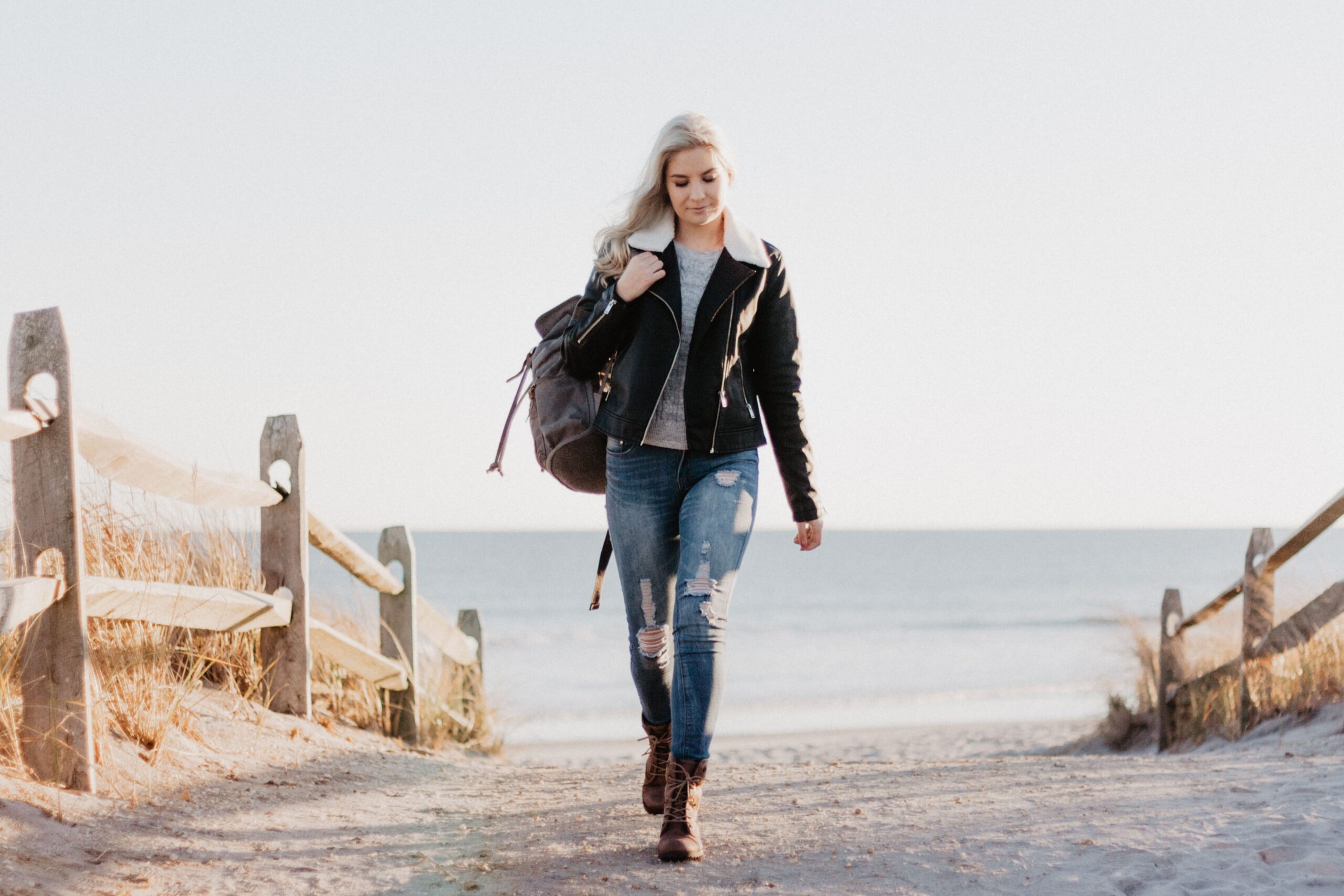 Young Woman With Backpack Walking back From Beach