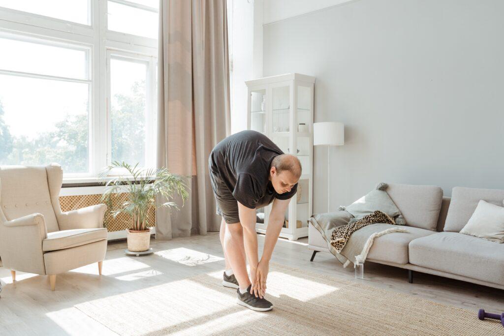 Man Exercising In Living Room