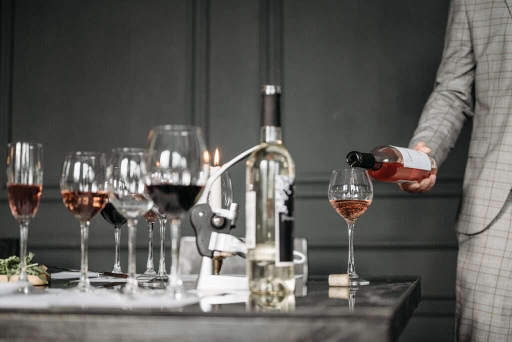 Wine Glasses And Wine Being Poured